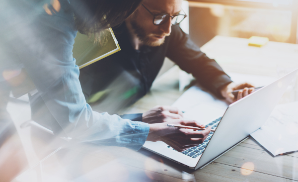 Team work process. Photo young business crew working with new startup project laptop. Project managers meeting. Analyze plans, papers. Blurred background, film effect